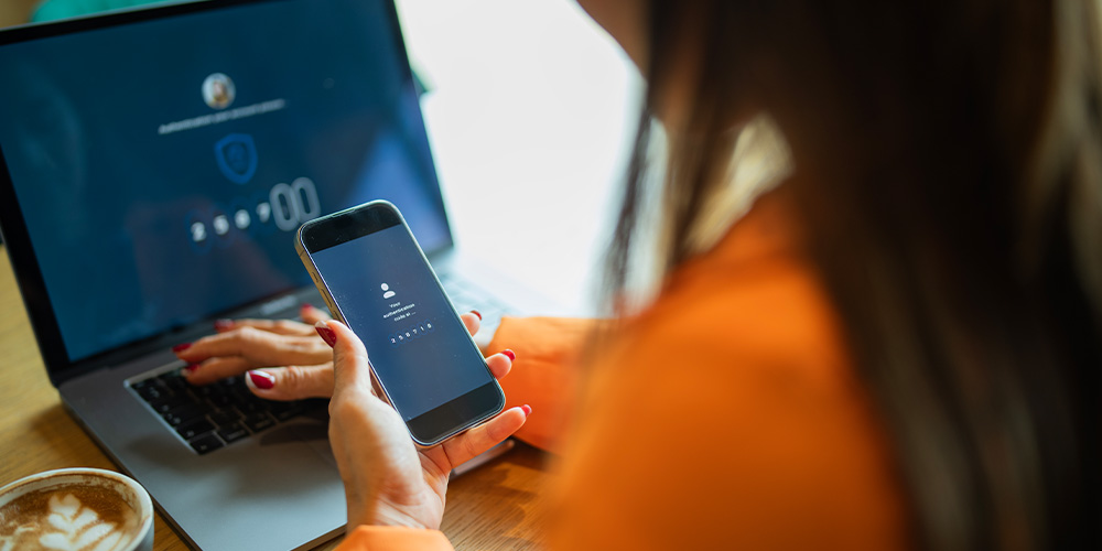 Woman on phone and computer typing password