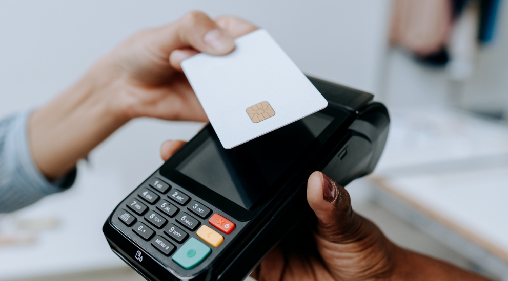 woman paying on merchant tablet