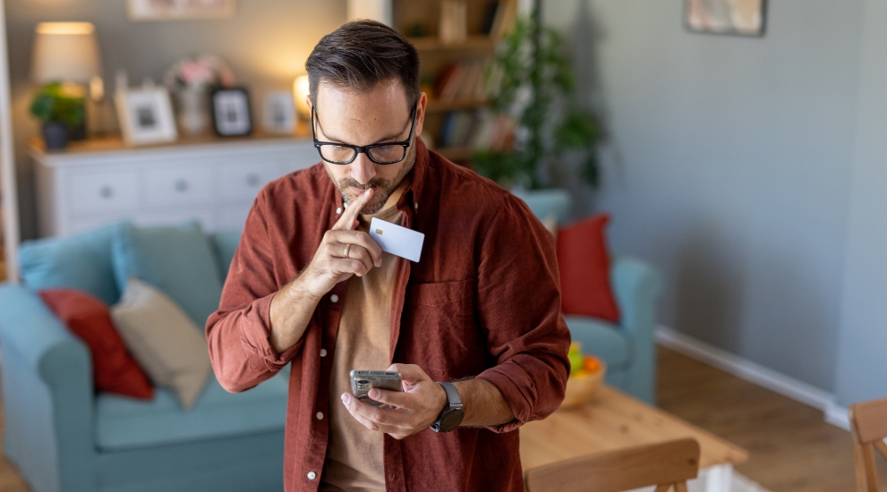 man with card displaying fraud
