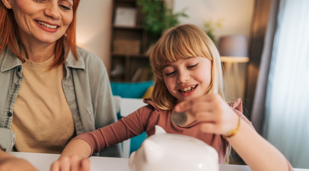 mom and daughter with piggy bank