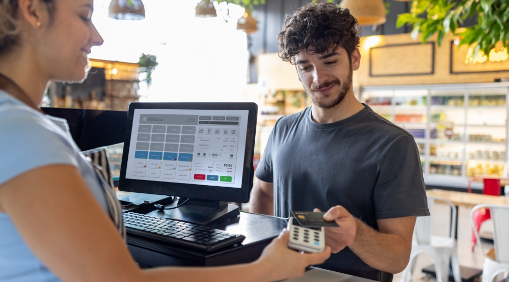 person at gas pump with debit card