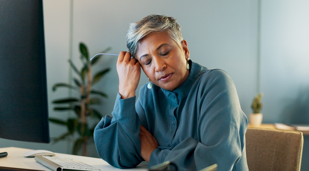 older woman holding head