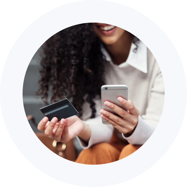 Woman holding debit card & phone